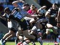 Exeter Chiefs' Henry Slade in action with Sale Sharks' Tom Curry and Jean-Luc du Preez on June 12, 2021