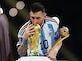 Argentina's Lionel Messi kisses the World Cup trophy after collecting the Golden Ball award on December 18, 2022