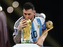 Argentina's Lionel Messi kisses the World Cup trophy after collecting the Golden Ball award on December 18, 2022