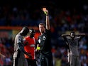 Tottenham Hotspur's Yves Bissouma is shown a red card by referee John Brooks on October 7, 2023